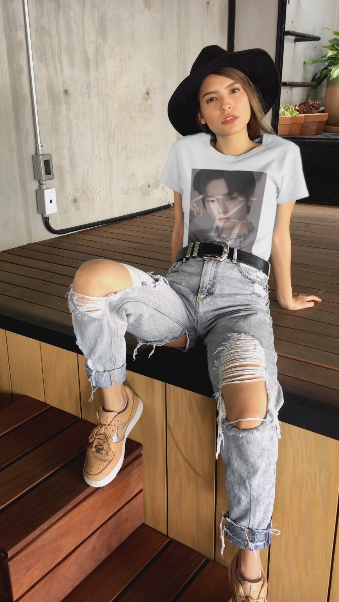 Video showcasing the Yang Jeong-in I.N Stray Kids unisex cotton t-shirt in white, featuring a Y and J layer mask effect that reveals highlights of his face. Includes a silver chain and a gray sweater with brown circular parts made using intarsia knitting. Printed on 100% US cotton, ethically made and Oeko-Tex certified. ModeK Vetements.