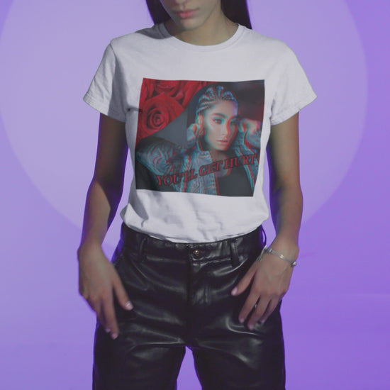 Video showcasing the Unisex cotton t-shirt in white, with glitch-effect design of a woman beside red roses and the text “You’ll get hurt.” Feminist message printed on 100% US cotton, ethically made and Oeko-Tex certified. ModeK Vetements.