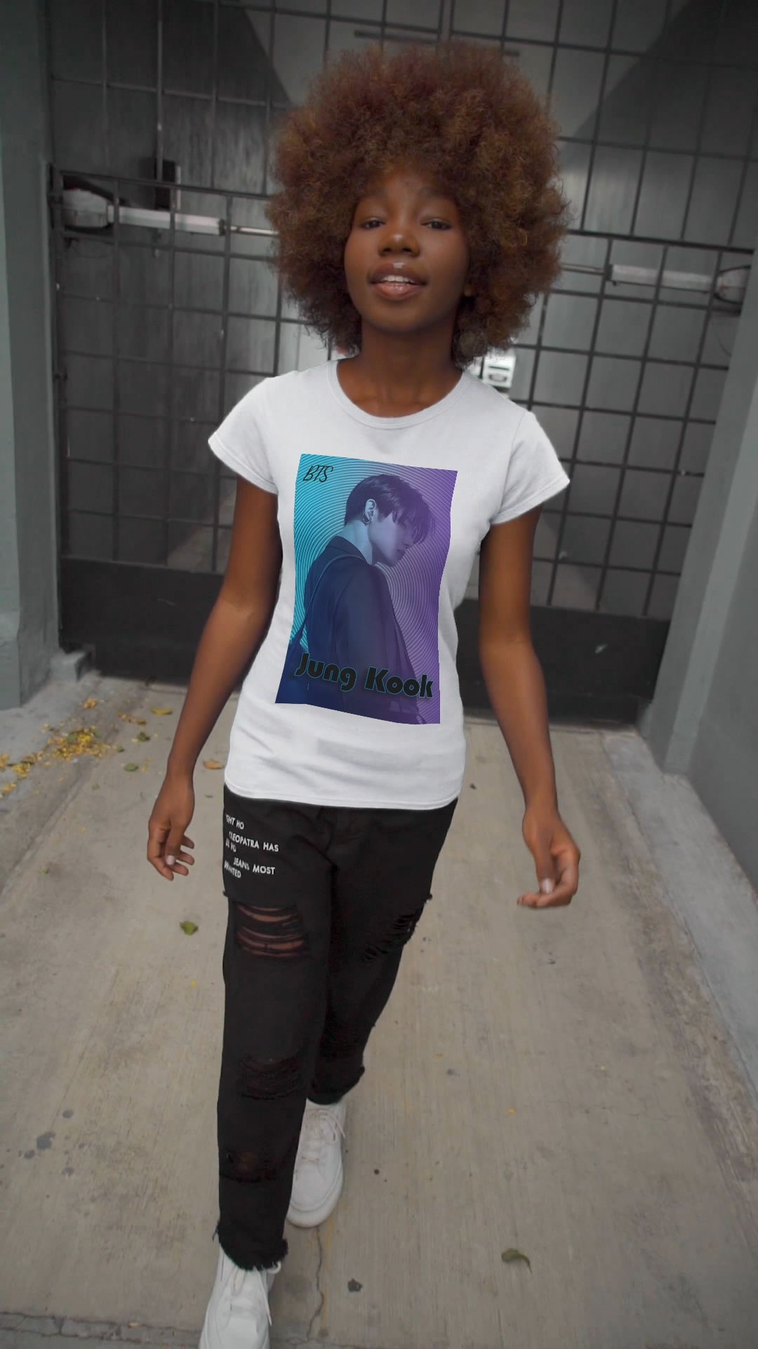 Video showcasing the Jung Kook Unisex T-shirt in white, featuring a cyan-to-lavender gradient, vinyl-inspired circular background, retro lettering, and profile portrait with suit and leather bag – cinematic unisex style. 100% Airlume combed and ringspun cotton. ModeK Vetements.