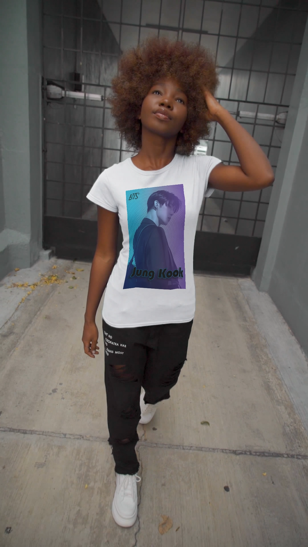 Video showcasing the Jung Kook BTS Unisex T-shirt in white, featuring a cyan-to-lavender gradient, vinyl-inspired circular background, retro lettering, and profile portrait with suit and leather bag – cinematic unisex style. 100% Airlume combed and ringspun cotton. ModeK Vetements.