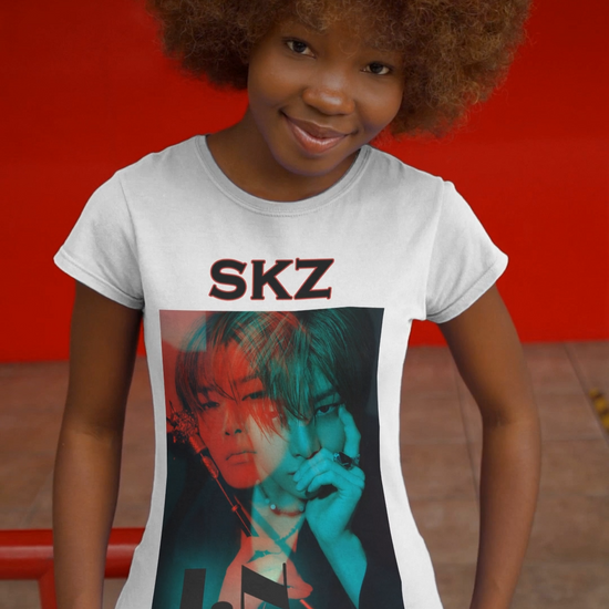 Video showcasing the I.N Stray Kids unisex T-shirt in white, featuring a bold black-and-white portrait with a dual-tone red and teal overlay. The striking 3D-like effect, combined with "SKZ" typography and I.N’s name, creates a modern, edgy aesthetic. Made from 100% cotton for lightweight comfort. From ModeKVetements.