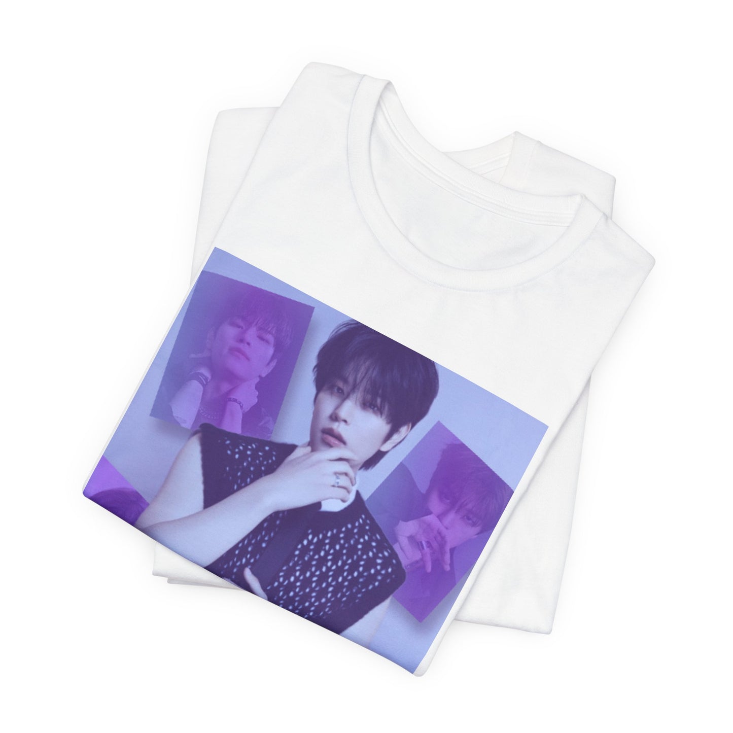Folded unisex, jersey, airlume combed and ringspun cotton T-Shirt in white, with a graphic design. It features Stray Kids' Seungmin in a sleeveless crochet top and blueberry tie. He poses thoughtfully against a periwinkle backdrop with a mist-covered collage of lavender, magazine-style photos. At the bottom, "SKZ SEUNGMIN" is written in pale lily-blue with a soft drop shadow. From ModeK Vetments.