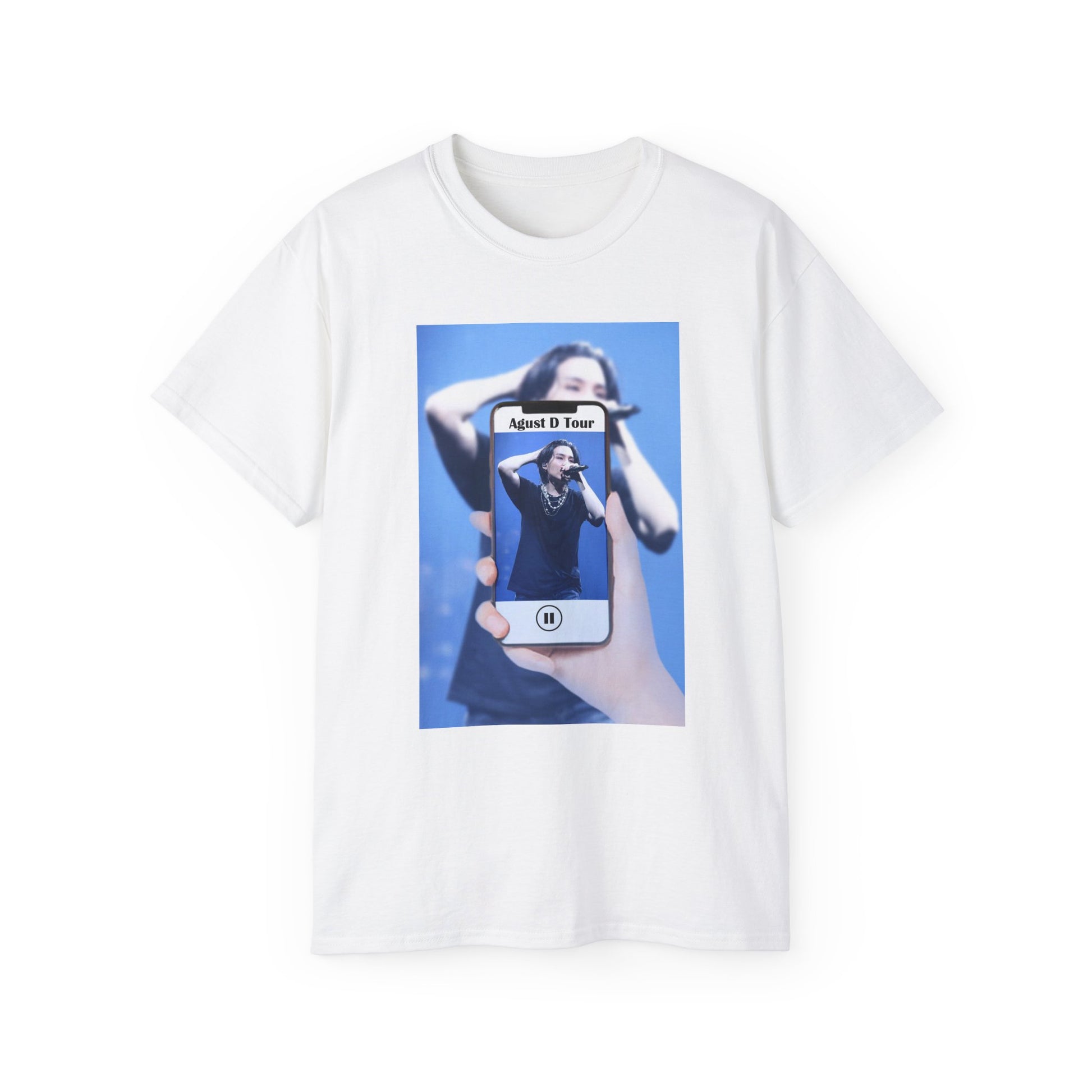 Draped unisex T-shirt in white, featuring BTS’s SUGA mid-performance during the Agust D Tour, shown through a phone screen with a video player overlay. The foreground is sharp and vivid, while the background is softly blurred. ModeK Vetements. 
