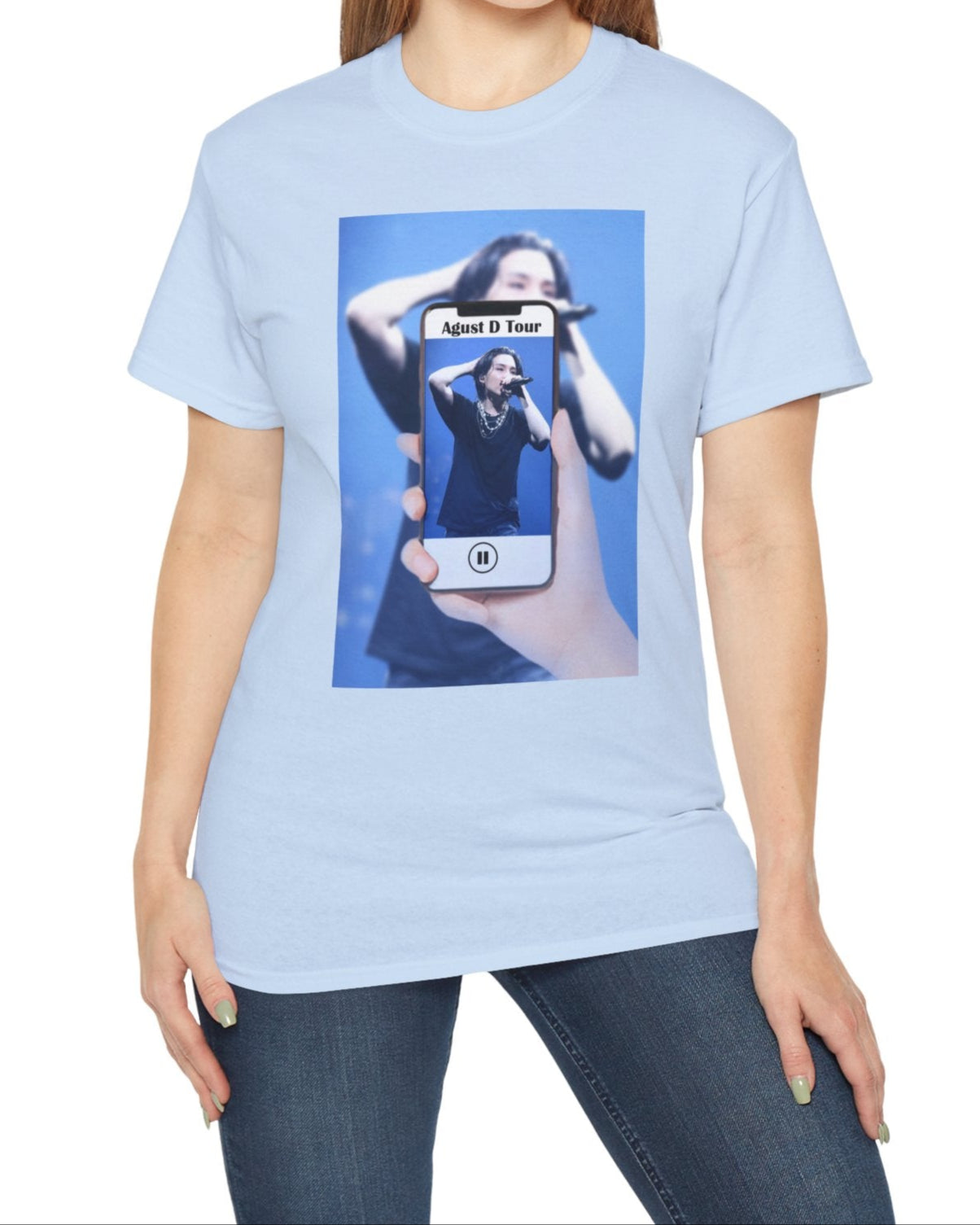 Unisex T-shirt in light blue, featuring BTS’s SUGA mid-performance during the Agust D Tour, shown through a phone screen with a video player overlay. The foreground is sharp and vivid, while the background is softly blurred. ModeK Vetements. 