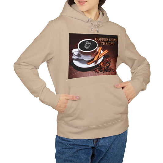 Unisex hoodie in desert dust, with front graphic showing a white porcelain coffee cup surrounded by cinnamon sticks, star anise, and coffee beans, with a dark foam surface blooming into a subtle flower shape. 100% organic, combed and ring-spun cotton from ModeK Vetements.