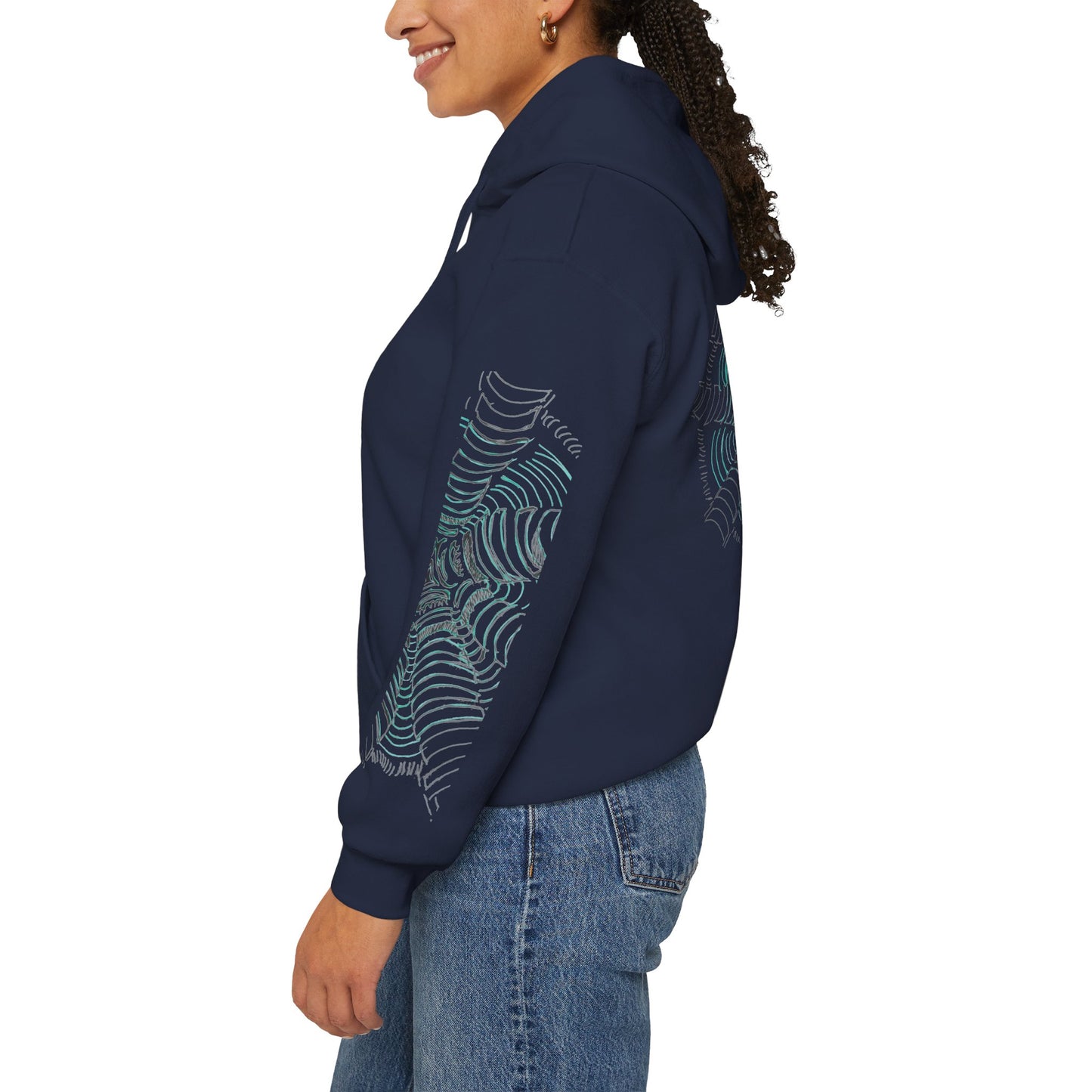 Left sleeve of the unisex heavy blend hoodie in navy featuring a hand-drawn psychedelic zentangle artwork. Eight segmented white pillars radiate outward from a complex center, surrounded by concentric electric teal ripples that curve inward to create a powerful 3D tunnel effect and optical illusion of movement. From ModeK Vetements.