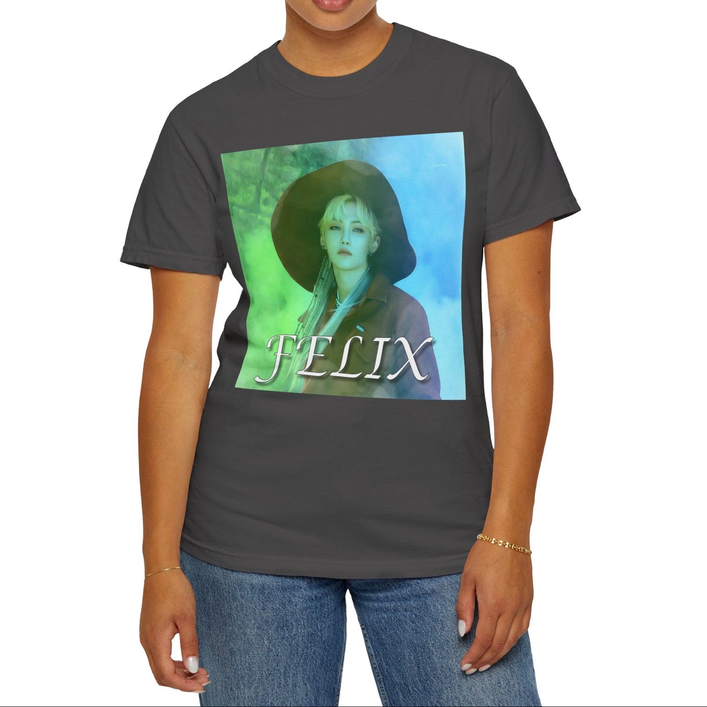 Unisex 100% ring-spun cotton T-Shirt in graphite, featuring a portrait of Stray Kids' Felix wearing a large hat. It is as if he was painted on canvas with the effect of a mist, blending soft light blue and light green tones. From ModeK Vetements.