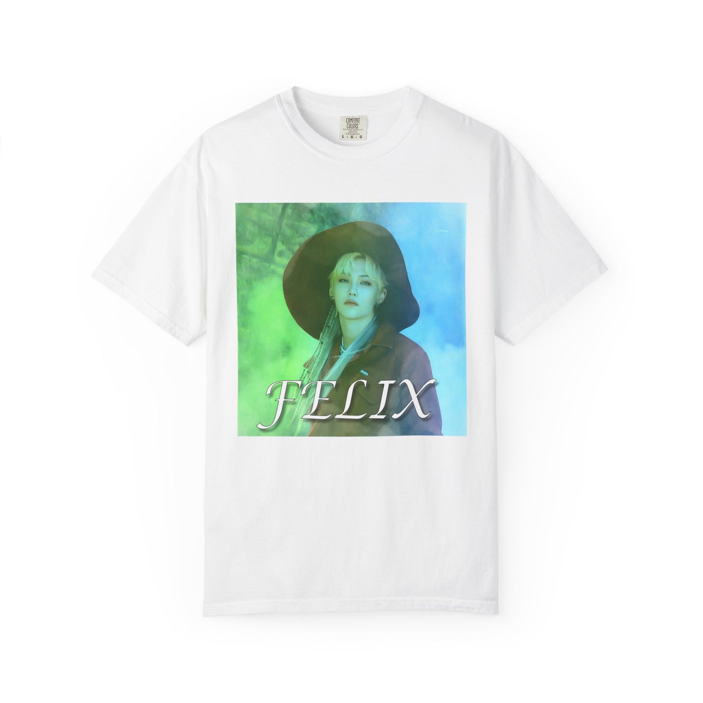 Draped Unisex 100% ring-spun cotton T-Shirt in white, featuring a portrait of Stray Kids' Felix wearing a large hat. It is as if he was painted on canvas with the effect of a mist, blending soft light blue and light green tones. From ModeK Vetements.