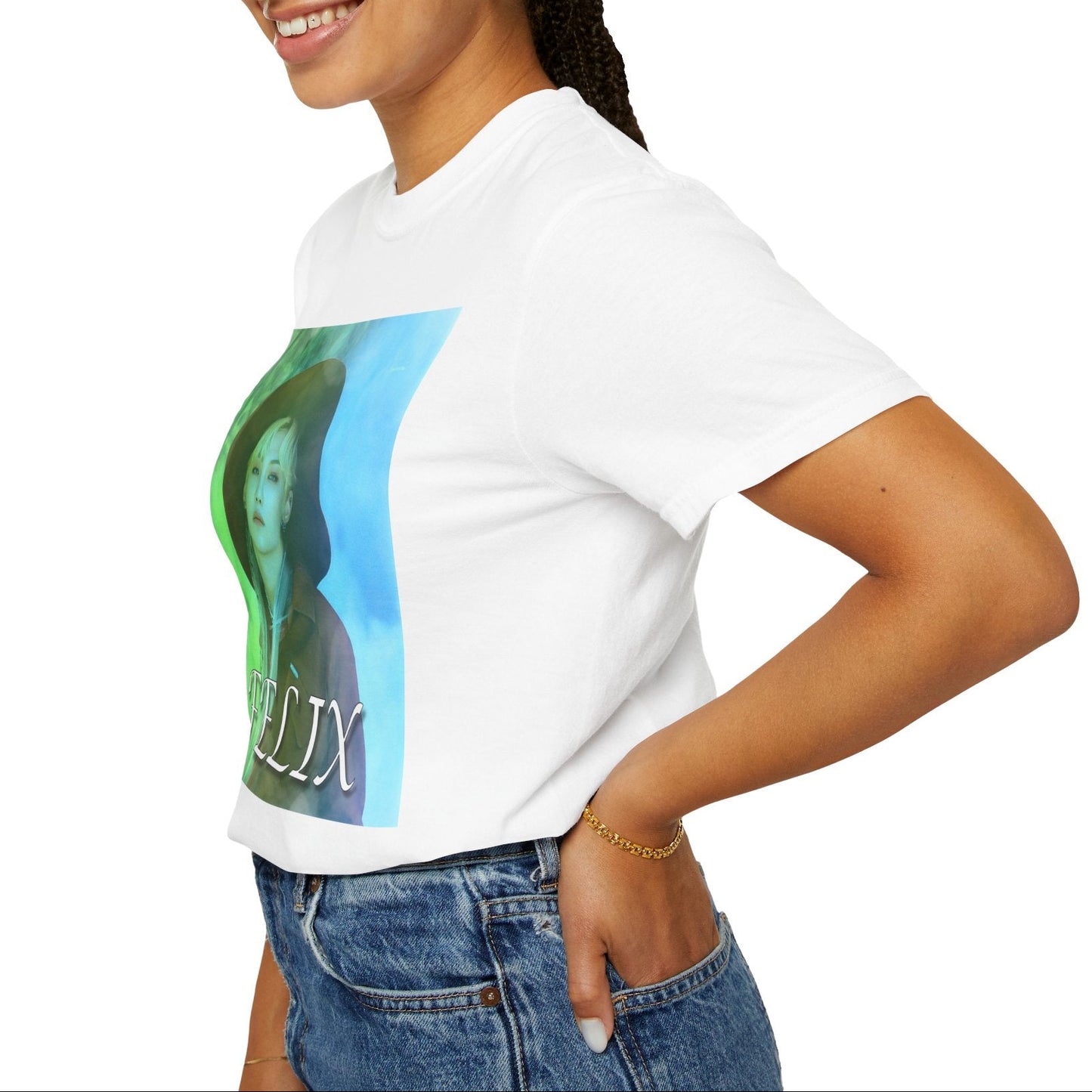 Profile view of the Unisex 100% ring-spun cotton T-Shirt in white, featuring a portrait of Stray Kids' Felix wearing a large hat. It is as if he was painted on canvas with the effect of a mist, blending soft light blue and light green tones. From ModeK Vetements.