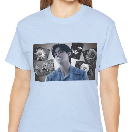 Unisex cotton T-shirt in light blue, featuring a portrait of BTS’s Taehyung (V) holding a blue flower in his mouth, surrounded by grayscale images of a rose, sakura, water lily, dahlia, and rabelera in a collage-style background. ModeK Vetements.