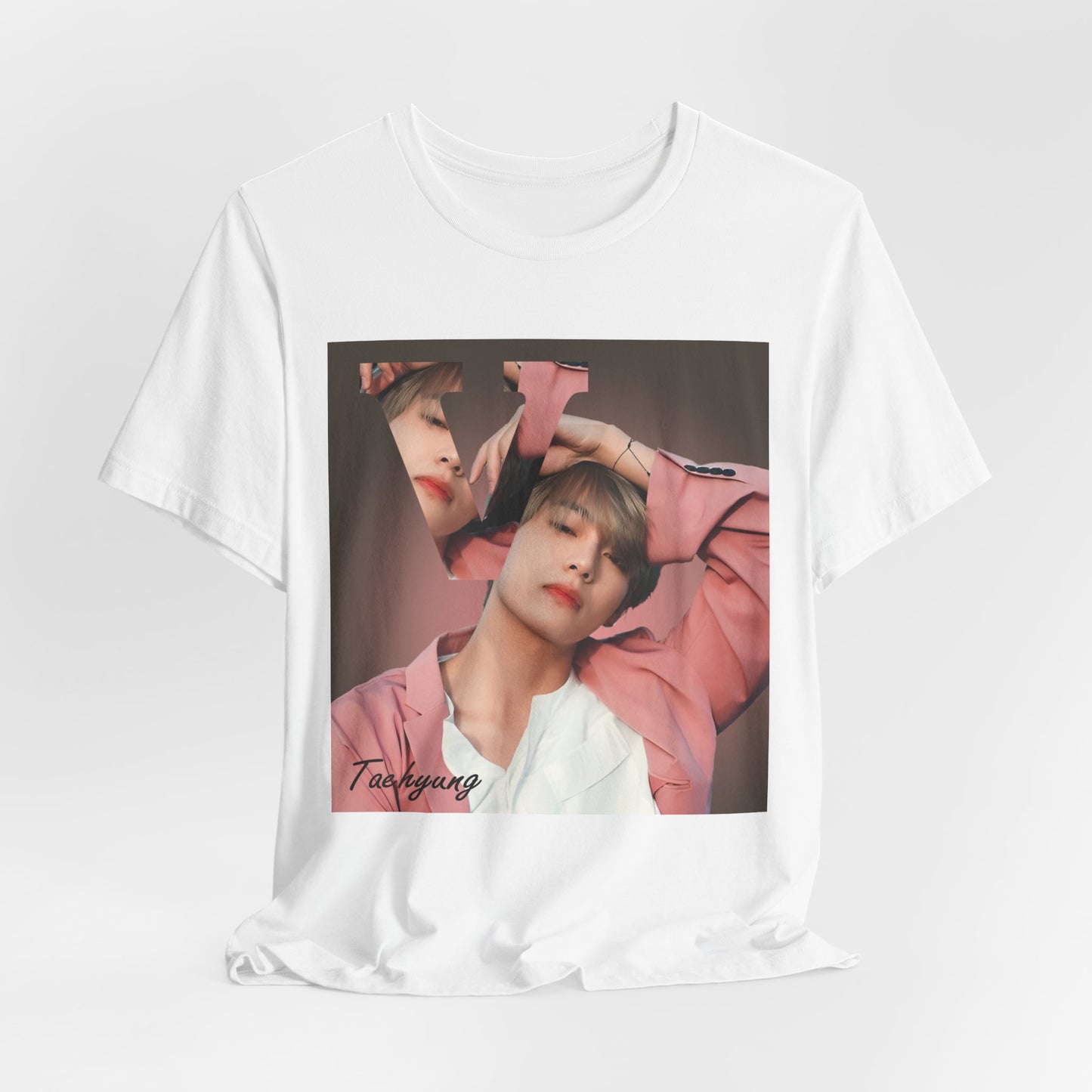 Draped V BTS Unisex T-Shirt in white – A seamlessly blended design capturing V’s unpredictable, dreamy essence. Aesthetic pink tones enhance his depth and artistic allure. 100% Airlume conbed and ring-spun cotton from ModeK Vetements.
