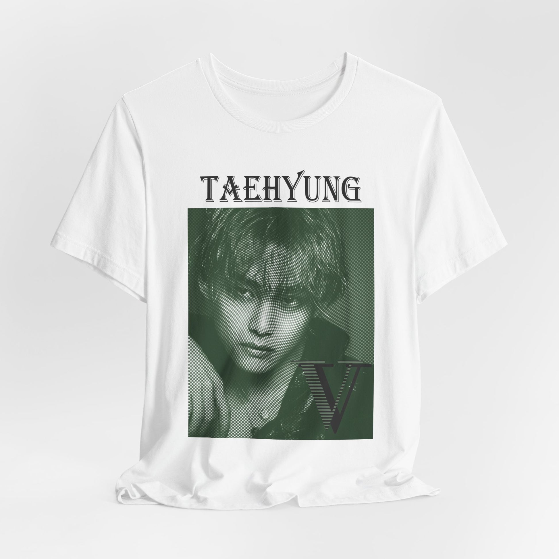 V Taehyung BTS unisex T-shirt in white, displayed in a relaxed draped style. Features a vintage money engraving effect on a deep green-toned portrait, blending classic elegance with modern artistic detail. Made from 100% Airlume cotton for lightweight comfort. From ModeKVetements.