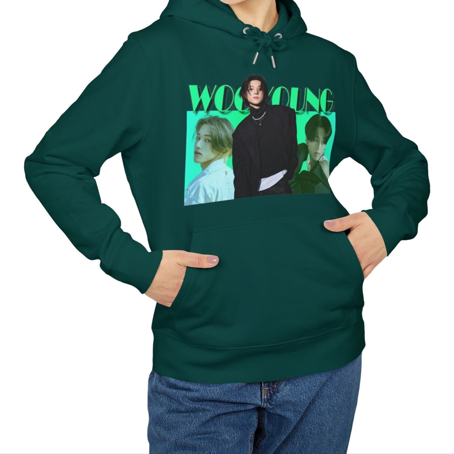 Unisex hoodie in glazed green, from 100% organic cotton, featuring a photo collage of ATEEZ’s Wooyoung. The central full-body image shows him in a black jacket with a pearl necklace and three safety pins, stepping forward over two bust-level side portraits. Background fades from aquamarine to green-cyan, with bold wintergreen “WOOYOUNG” text above. ModeK Vetements.