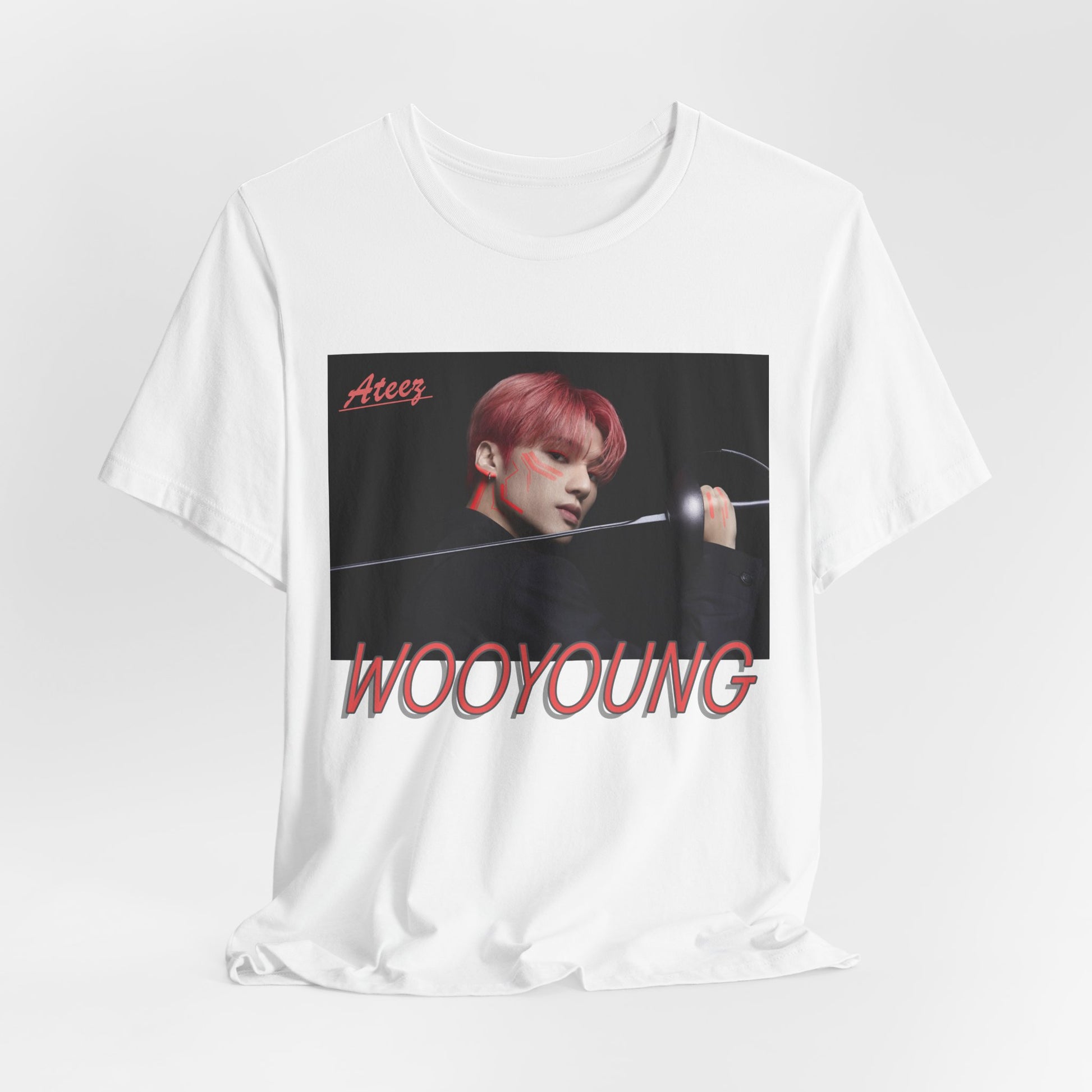 Draped Wooyoung ATEEZ Unisex T-Shirt featuring a bold design of Wooyoung wielding a sword, his pink-red hair and striking cheekbones accentuated by dynamic lighting. A must-have for ATINY.