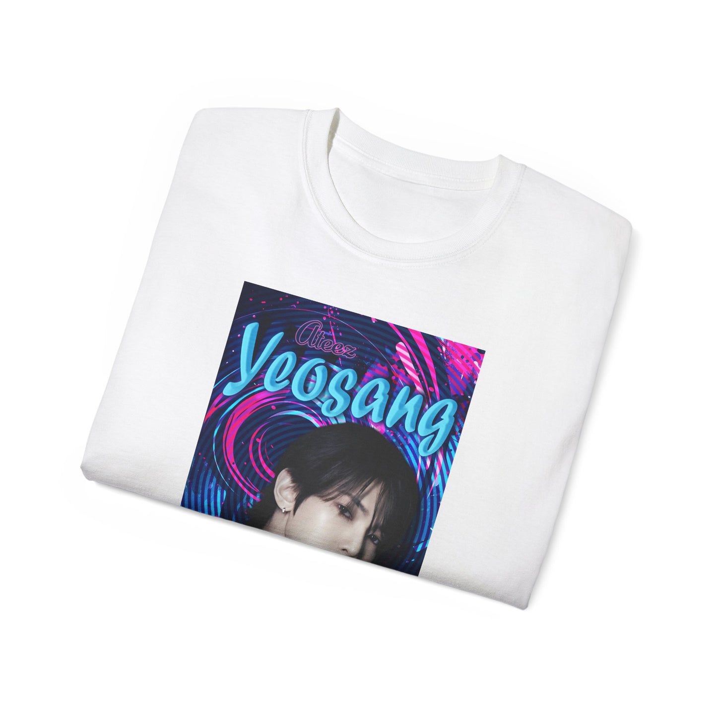 Folded unisex cotton t-shirt in white, featuring a portrait of Yeosang of ATEEZ surrounded by concentric digital lines and flowing paint-like textures. The design blends graffiti-inspired lettering with koi-like motion in blue lagoon and pink hues. From ModeK Vetements.