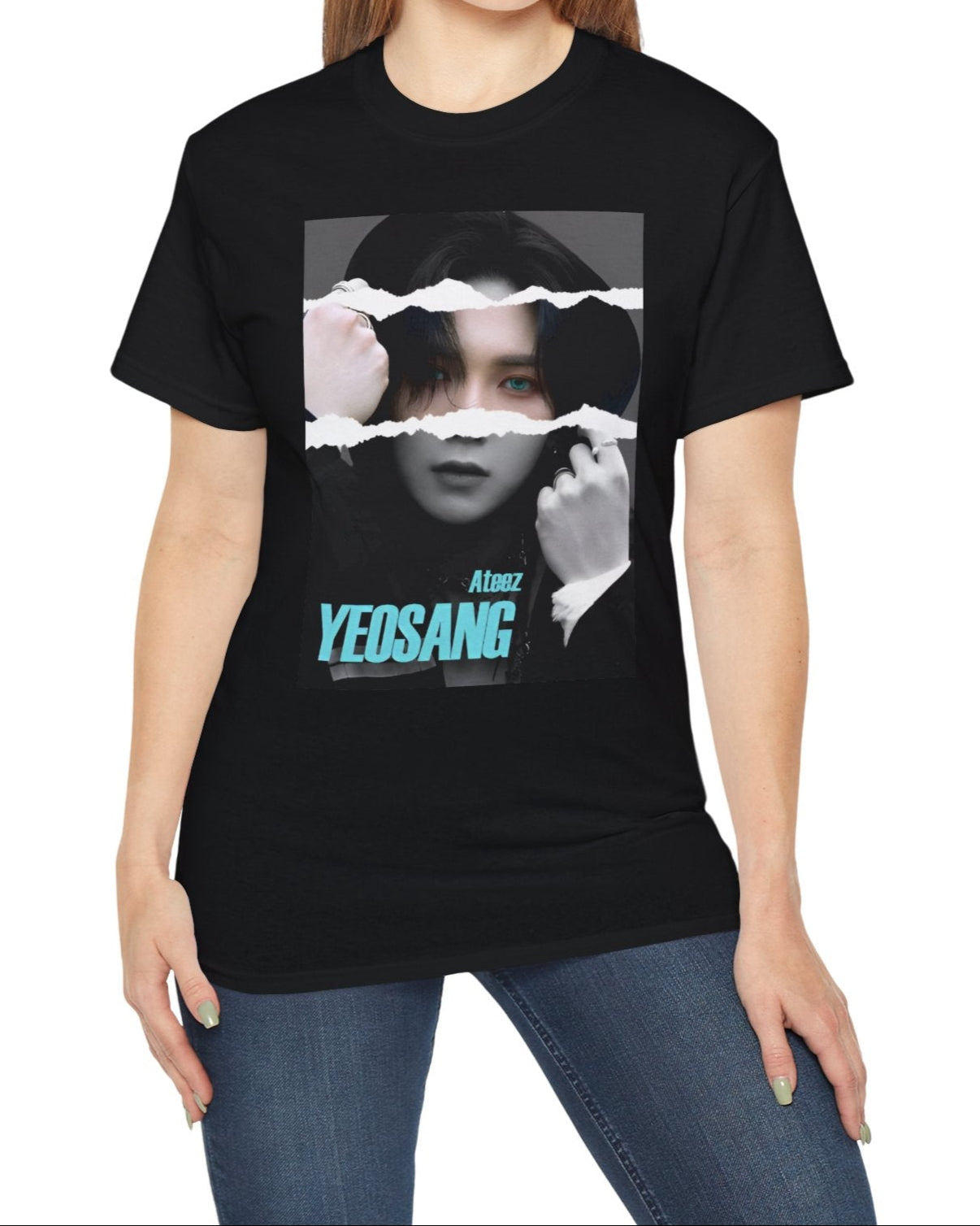 Yeosang ATEEZ graphic unisex t-shirt in black, with a black-and-white portrait featuring a torn-paper effect revealing a single colored strip with turquoise eyes and text. Yeosang is putting a hoodie over his head, creating a quiet, enigmatic presence. From ModeKVetements.
