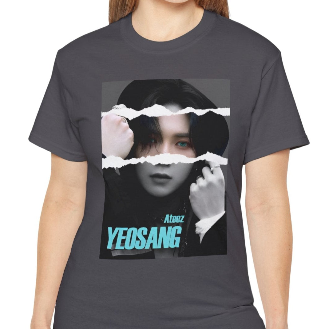 Yeosang ATEEZ graphic unisex t-shirt in charcoal, with a black-and-white portrait featuring a torn-paper effect revealing a single colored strip with turquoise eyes and text. Yeosang is putting a hoodie over his head, creating a quiet, enigmatic presence. From ModeKVetements.
