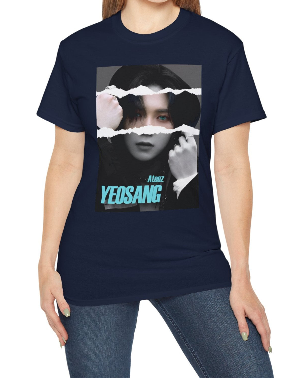 Yeosang ATEEZ graphic unisex t-shirt in navy, with a black-and-white portrait featuring a torn-paper effect revealing a single colored strip with turquoise eyes and text. Yeosang is putting a hoodie over his head, creating a quiet, enigmatic presence. From ModeKVetements.