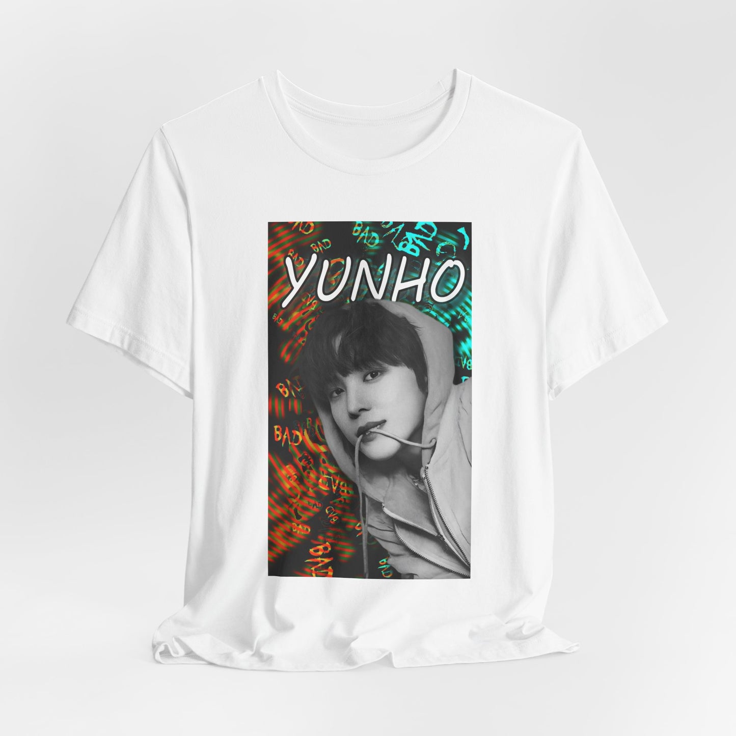 Draped Unisex airlume combed & ring-spun cotton t-shirt in white, featuring Yunho of ATEEZ in monochrome, biting a drawcord, as glitchy concentric ripples pulse around him. Ferrari red melts into aqua and green — a tempest of color and emotion, suspended mid-thought. From ModeKVetements.